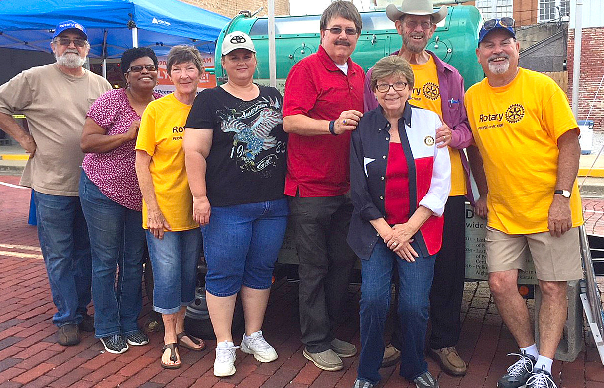Mineola Rotary Club members, from left, Frank Taylor, Judge Janae Holland, Lou Steele, Monica Bailey, Roy Shockey, club President Mary Lookadoo, Frank Lookadoo and Greg Hollen with the iron lung display during the Iron Horse Festival recently in Mineola.